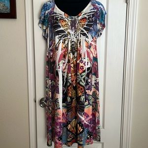 Jersey dress.  Sequins below the front neckline.  Has flutter type sleeves.